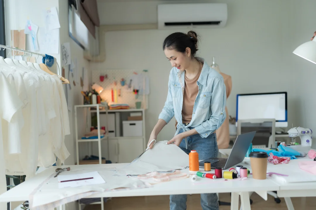 A business owner working at a studio workbench